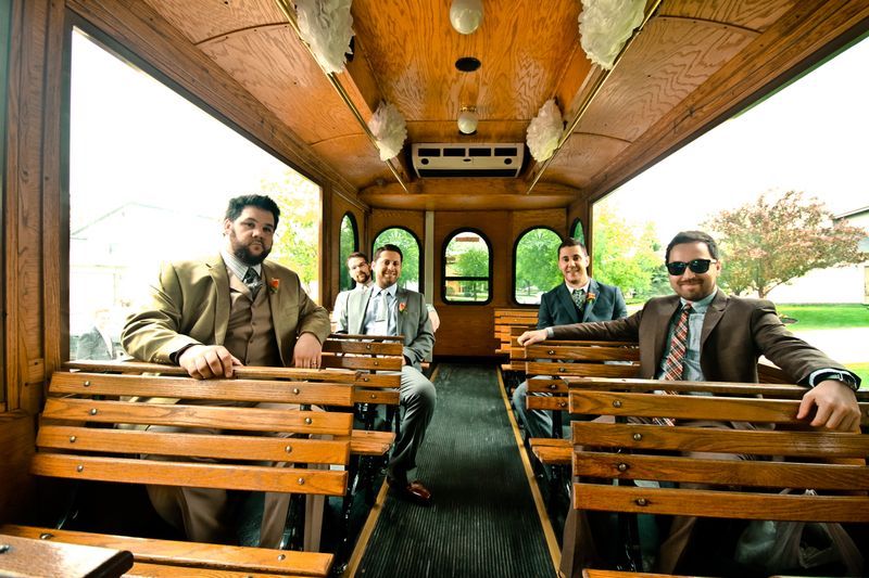 Groomsmen relaxing inside the wood-panelled trolley