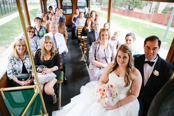 Wedding guests riding the trolley with the newlyweds