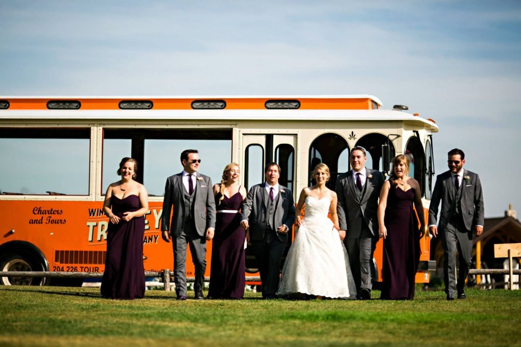 Wedding party posing in front of the trolley